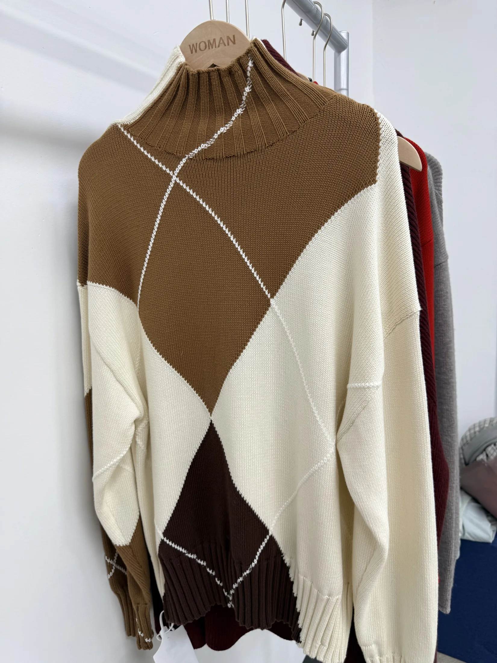 Colour-blocked intarsia knit sweater shown as a custom knitwear reference