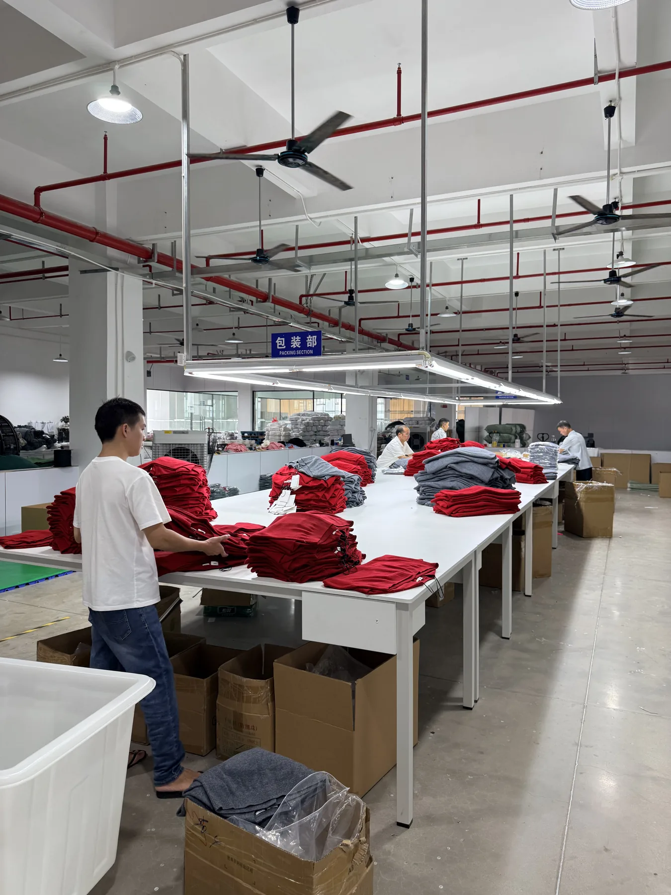Finished knitwear garments being prepared in the packing section
